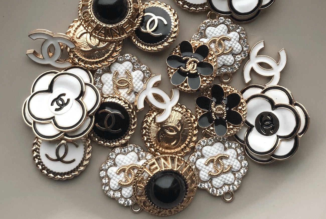 Vintage Chanel Buttons that will be repurposed into into pendant charms and hung on gold-filled chains.