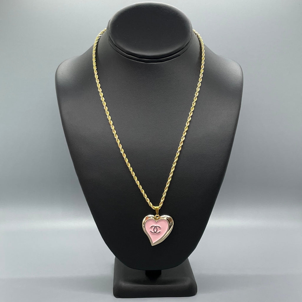 Elsa Peretti® Open Heart pendant in sterling silver with a pink sapphire.